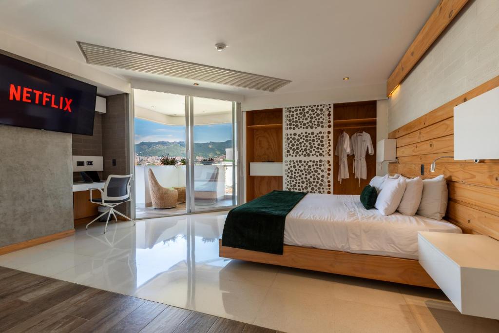 a hotel room with a bed and a desk at Terra Biohotel in Medellín