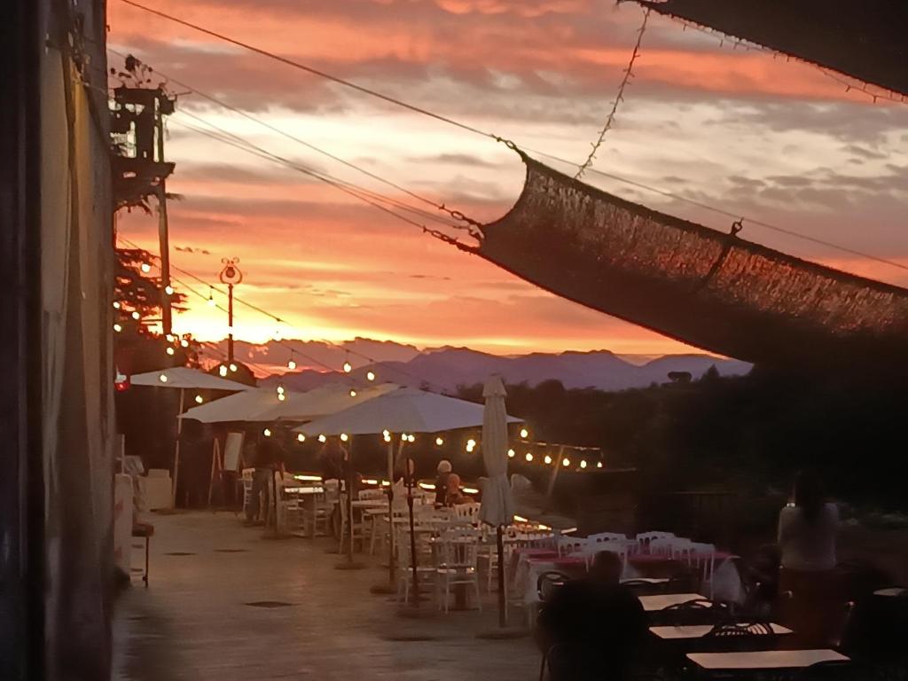 a group of tables and chairs with a sunset in the background at B&B Sunset Suite Belvedere 2 in Sant'Agata de' Goti