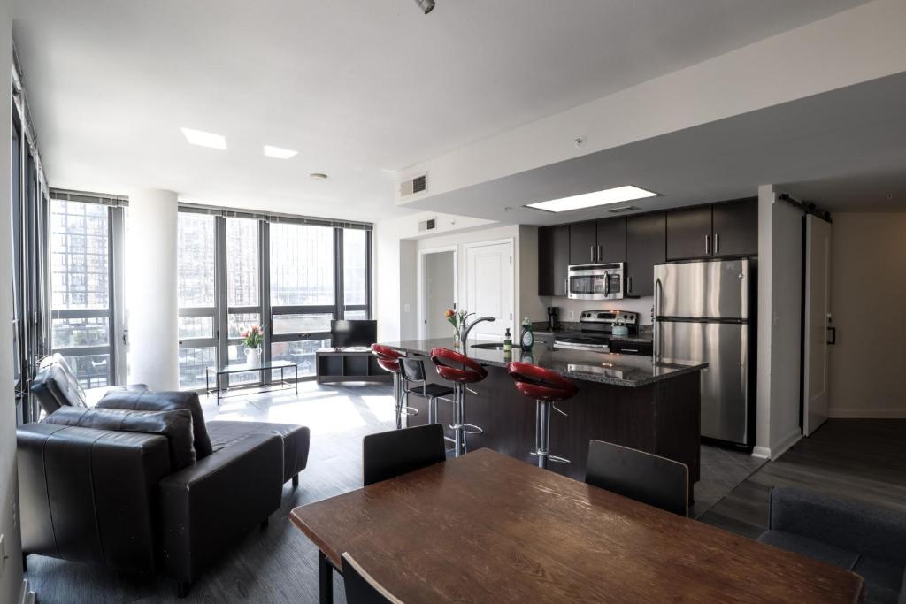 a kitchen and living room with a couch and a table at Pentagon Luxe Apartments Arlington - Near DC in Arlington