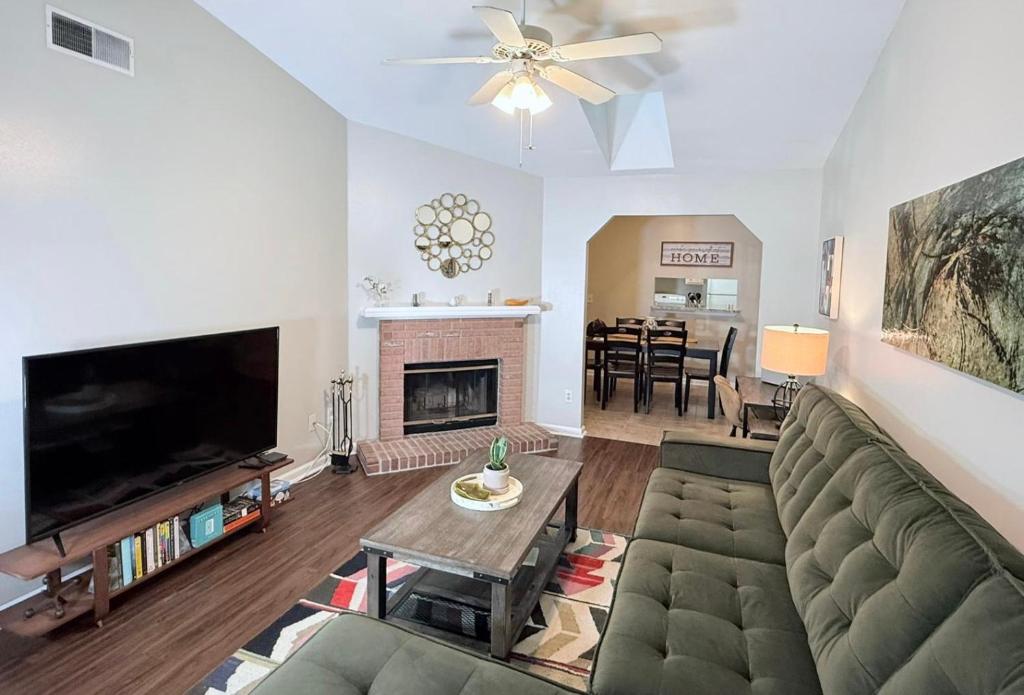 a living room with a couch and a fireplace at Pristine Elegance meets Chic Charm! in Tallahassee