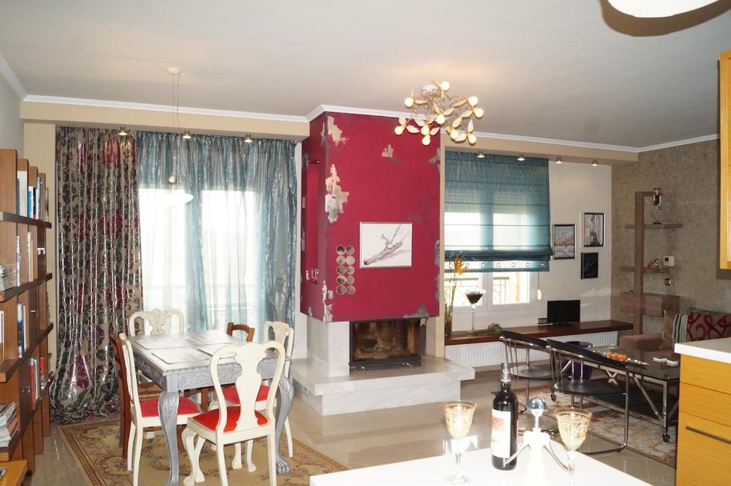 a living room with a table and a fireplace at Infinite blue Horizon Elegance Hospitality in Epanomi