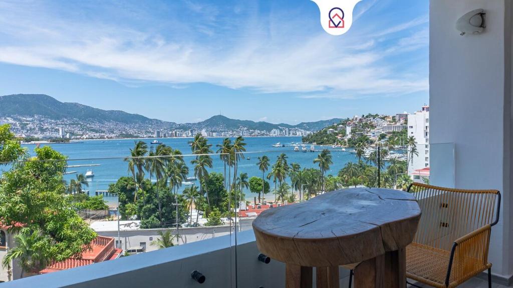 a balcony with a table and a view of the water at Apartment with Pool Acapulco 1 Bedroom in Acapulco