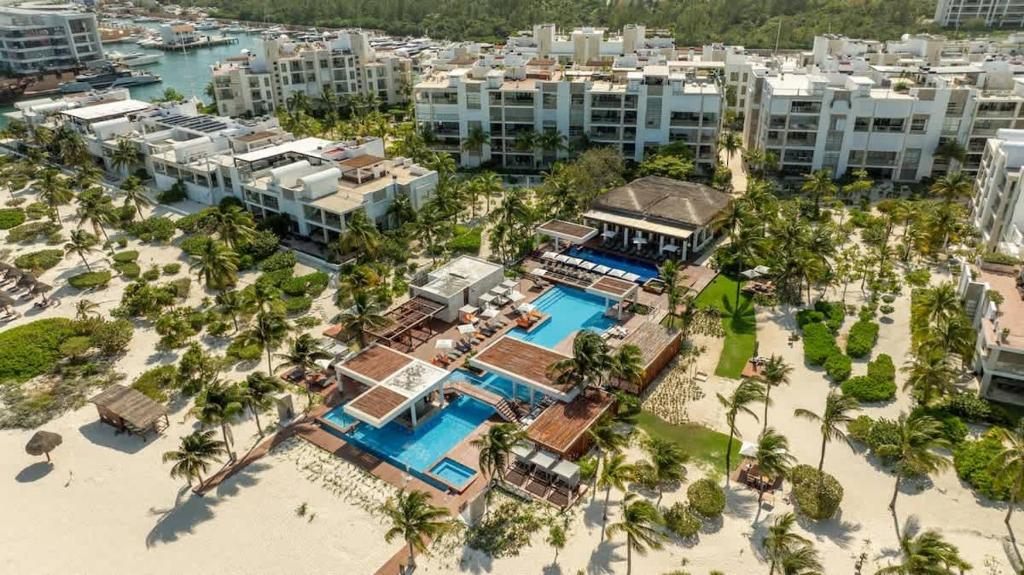 an aerial view of a resort with a pool at 3BR Beachfront Luxury Condo w/ Great Features in Cancún
