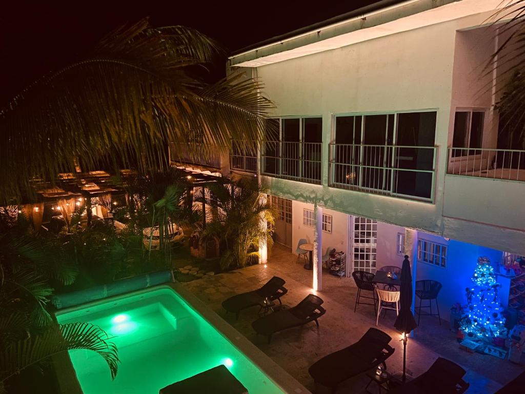 a house with a swimming pool at night at Casa Arena in Lo de Marcos
