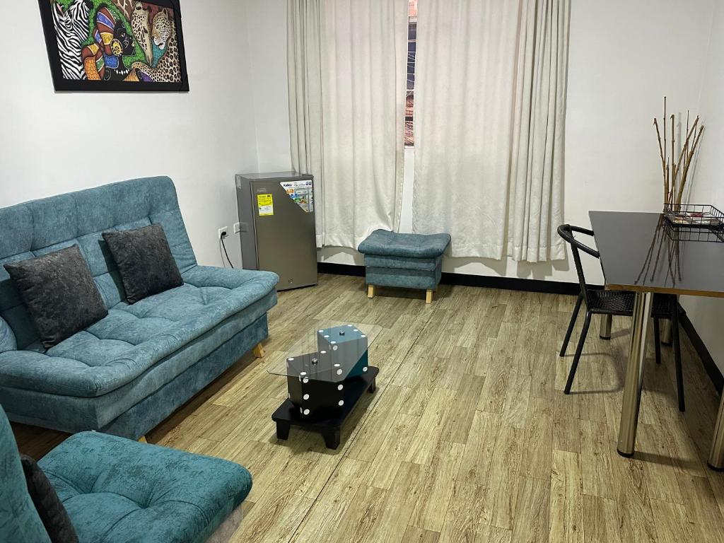 a living room with a couch and a table at Apartamentos FM 202 in Líbano