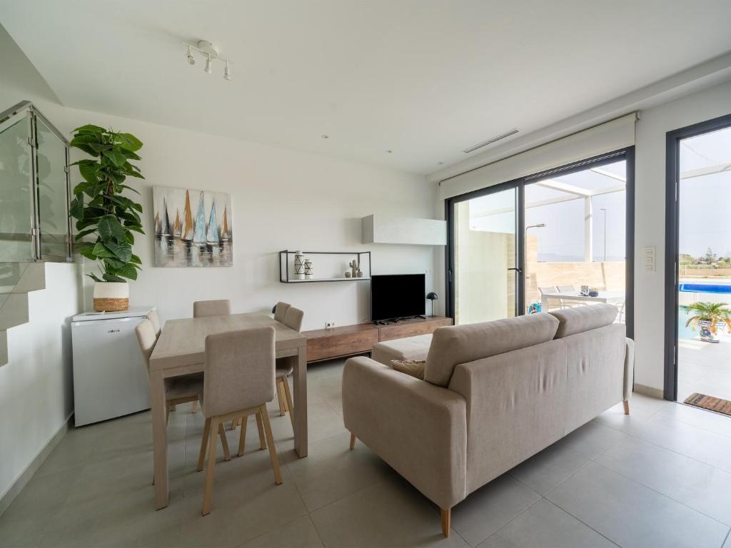 a living room with a couch and a table at Villa in Rojales with Pool near Coast in Rojales