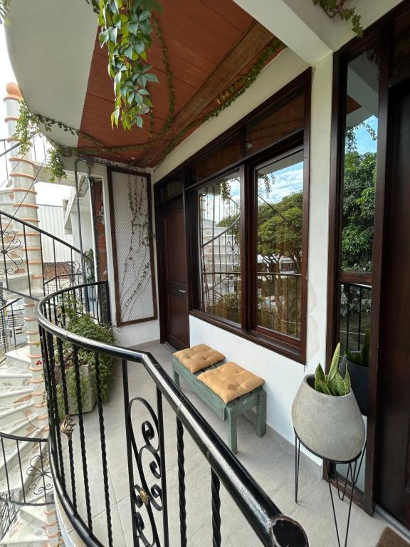a balcony of a house with a bench and windows at Nat!va 301 in Cali