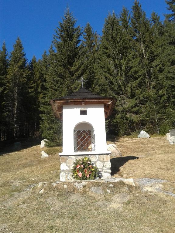a small chapel in a field with trees at Apartmány Grobarčík in Zuberec
