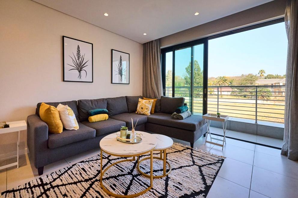 a living room with a couch and a table at Sandtongate Heights in Johannesburg