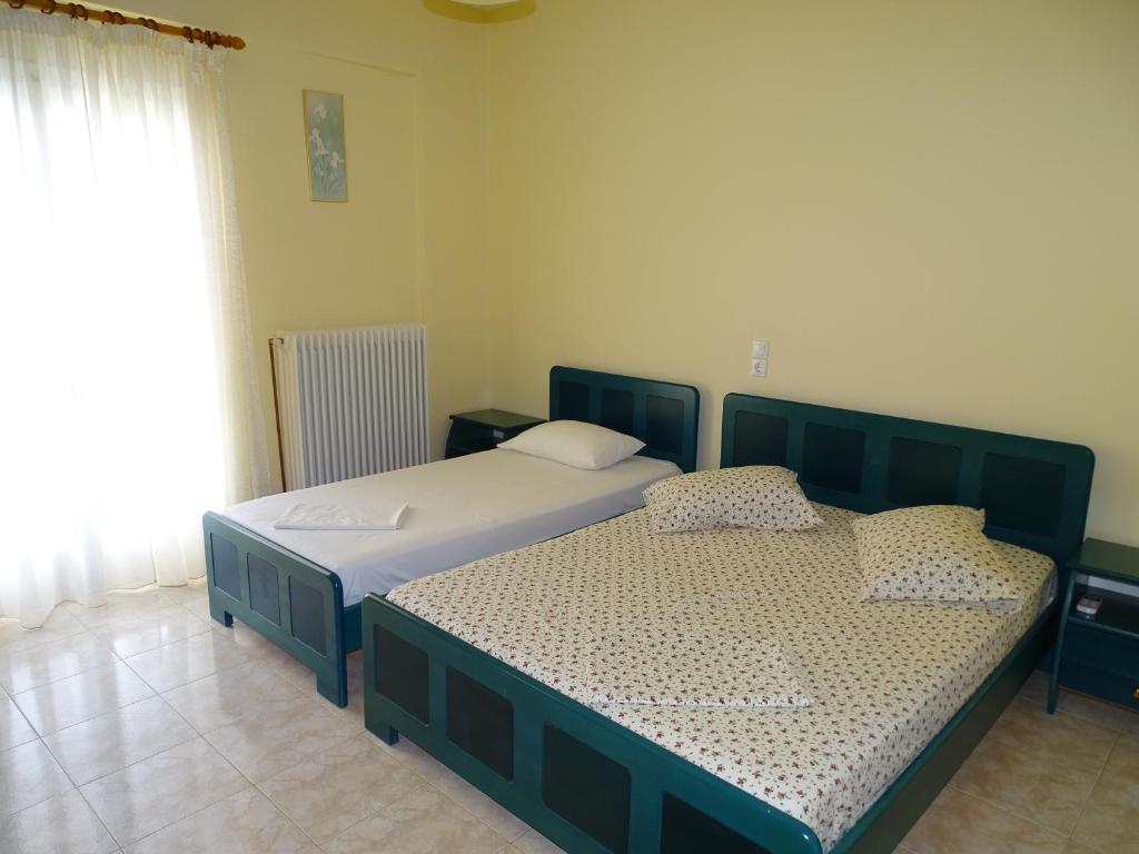 Postel nebo postele na pokoji v ubytování Flokos