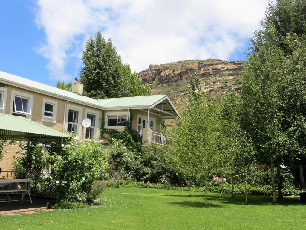 a house with a mountain in the background at Millpond House in Clarens