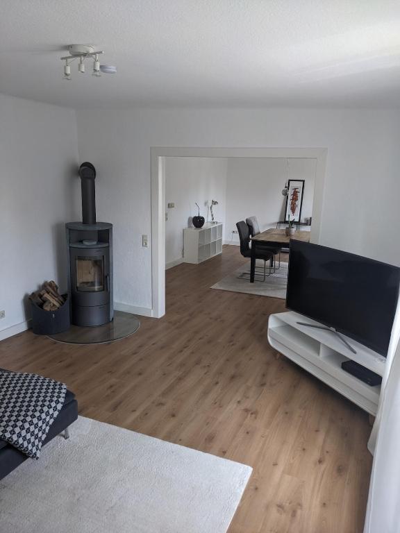 a living room with a fireplace and a flat screen tv at Fewo Steckinghof in Coesfeld