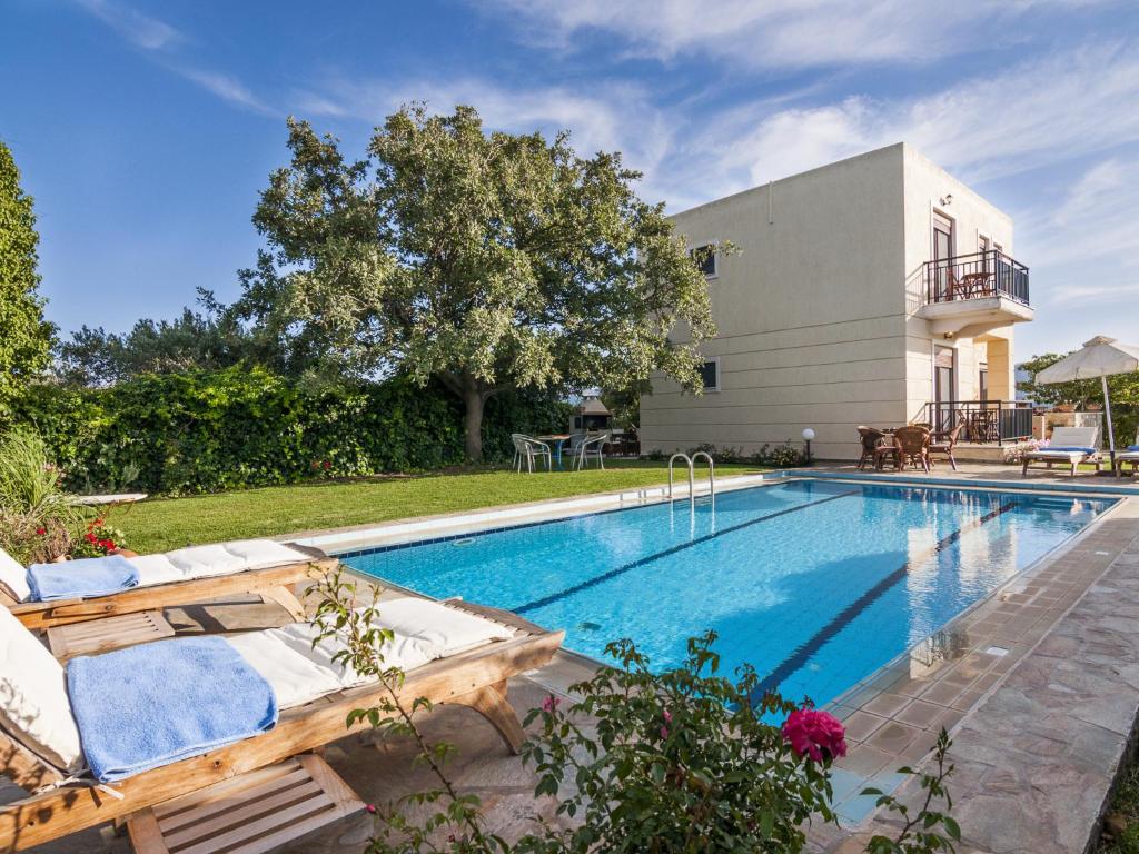 a swimming pool in the backyard of a house at Villa Kalliani in Kissamos