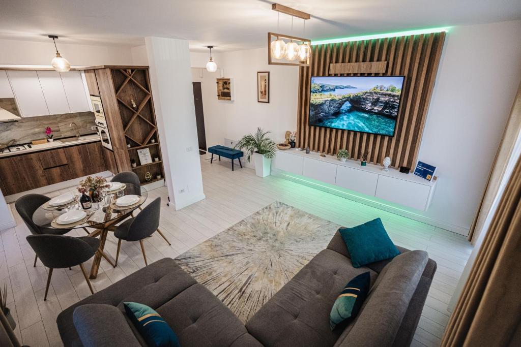 a living room with a couch and a table at Luxury Designer Apartment - Romanescu Park in Craiova
