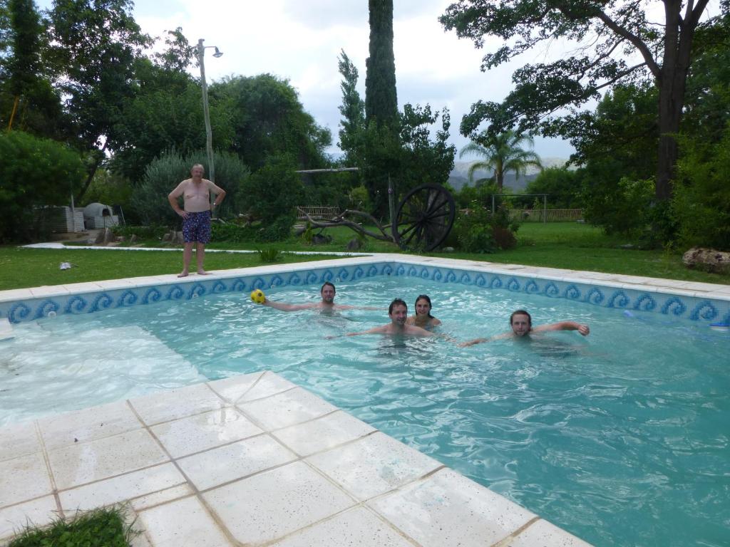 a group of people swimming in a swimming pool at Loft en Casona Colonial in Santa Rosa