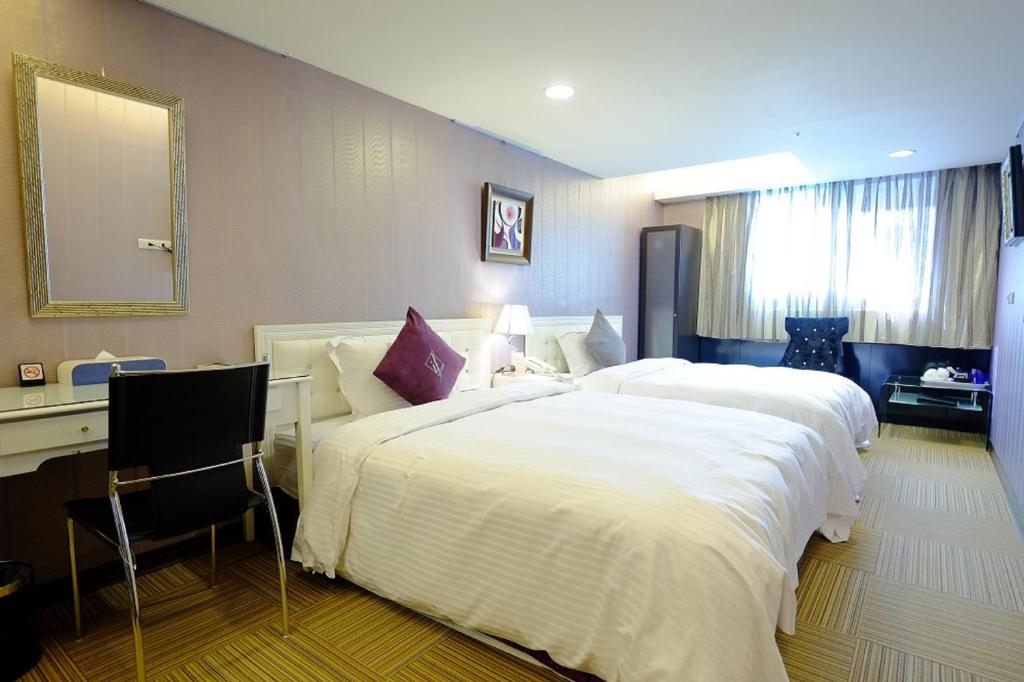 Postel nebo postele na pokoji v ubytování 意芙旅店 Ifinn Hotel