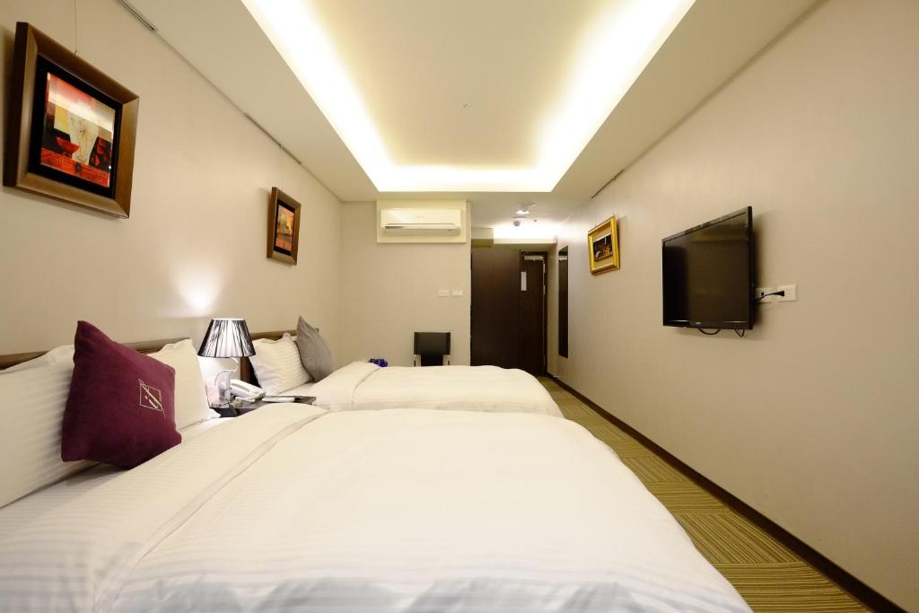 Postel nebo postele na pokoji v ubytování 意芙旅店 Ifinn Hotel