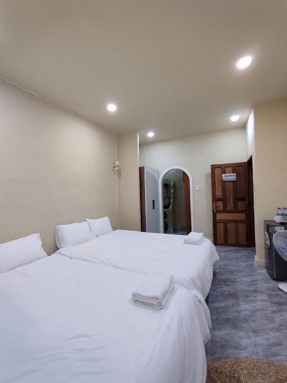 a bedroom with two beds with white sheets at Nắng Vĩnh Hy in Ninh Hải