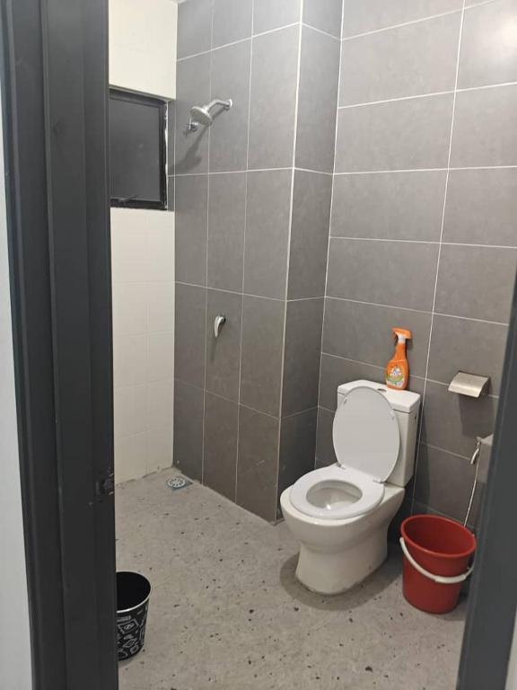 a bathroom with a toilet and a shower at The Cermai Homestay in Sungai Buluh