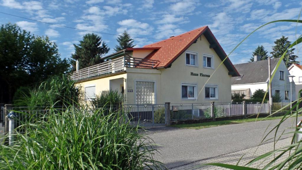 a white house with a red roof at Haus Floresa in Lutzmannsburg