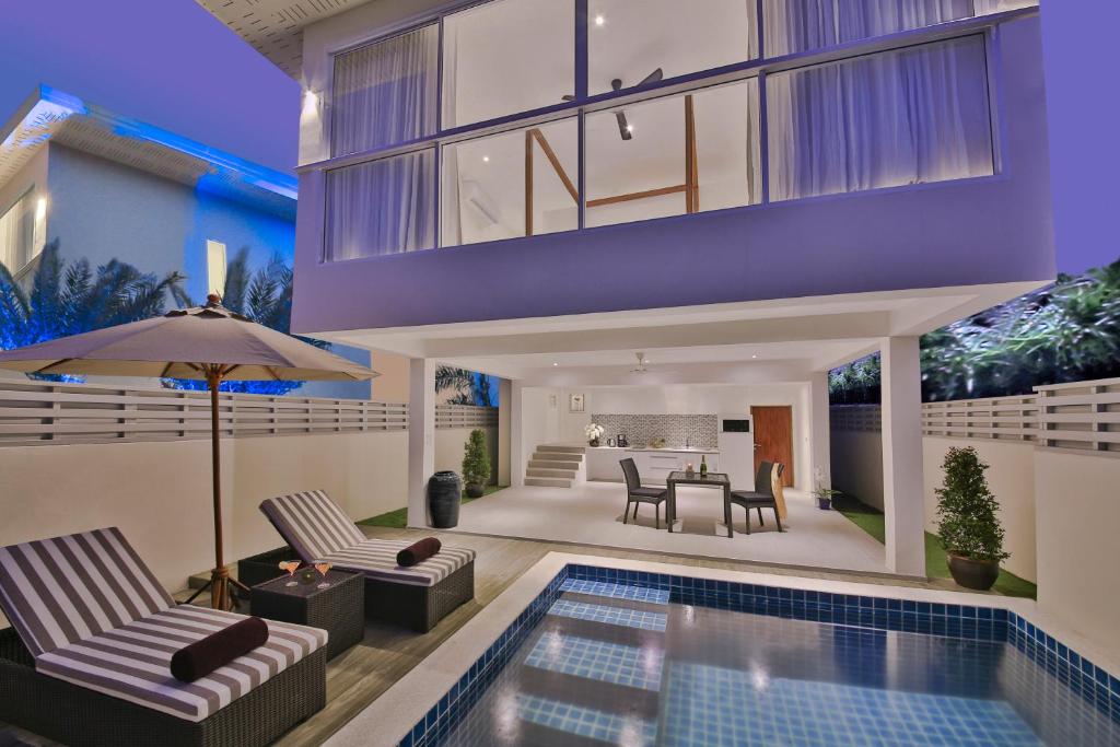 a house with a swimming pool and a living room at Samui Blue Orchid - Adult Only in Choeng Mon Beach
