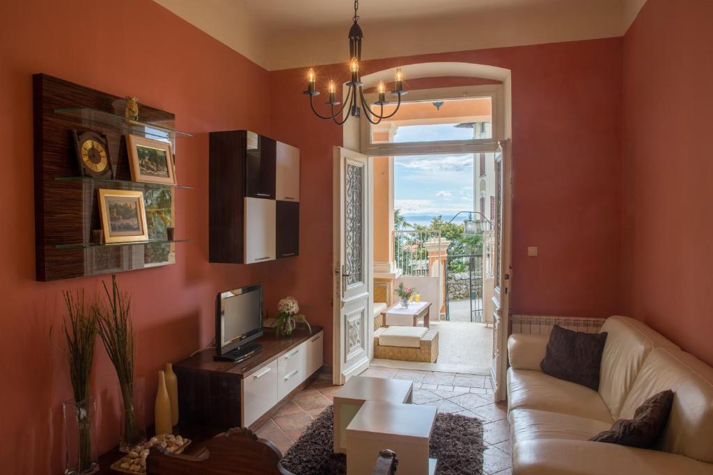 a living room with a couch and a tv at Apartment Bozic in Lovran
