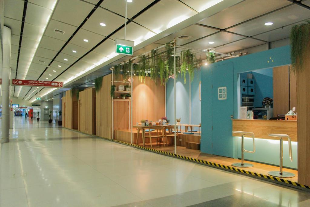 an empty hallway of a building with a restaurant at Boxtel @ Suvarnabhumi Airport in Lat Krabang