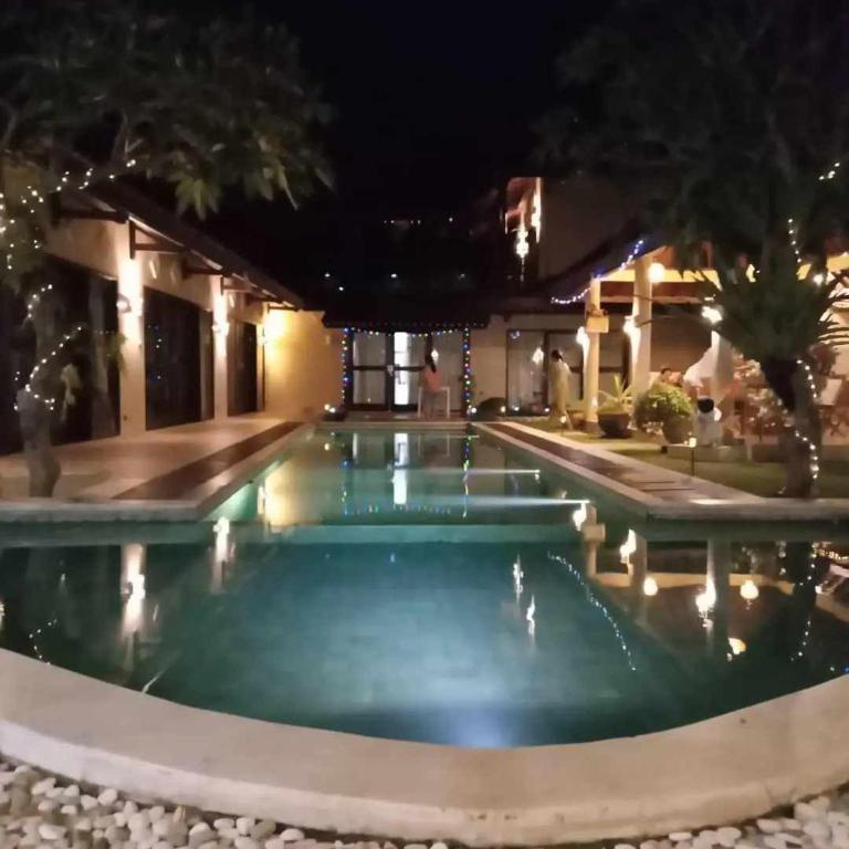 a pool in a hotel at night at The Paradise Bali in Badung