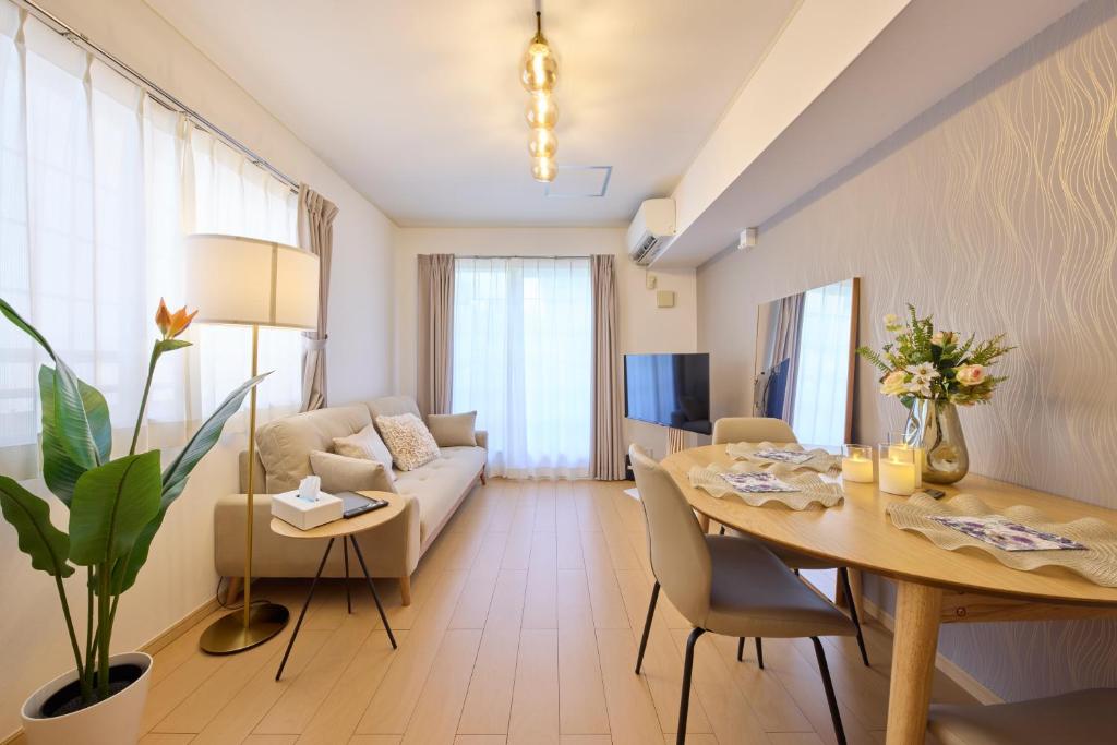 un salon avec une table et un canapé dans l'établissement シャンブル南行徳201, à Tokyo