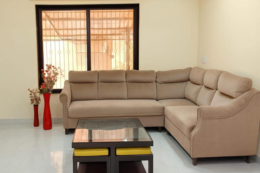 a living room with a couch and a coffee table at The Elite Villa 2 Bhk in Panchgani