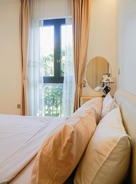 a bedroom with a bed with a large window at TH Villa, Vinhome Ocean Park, Hanoi in Hanoi