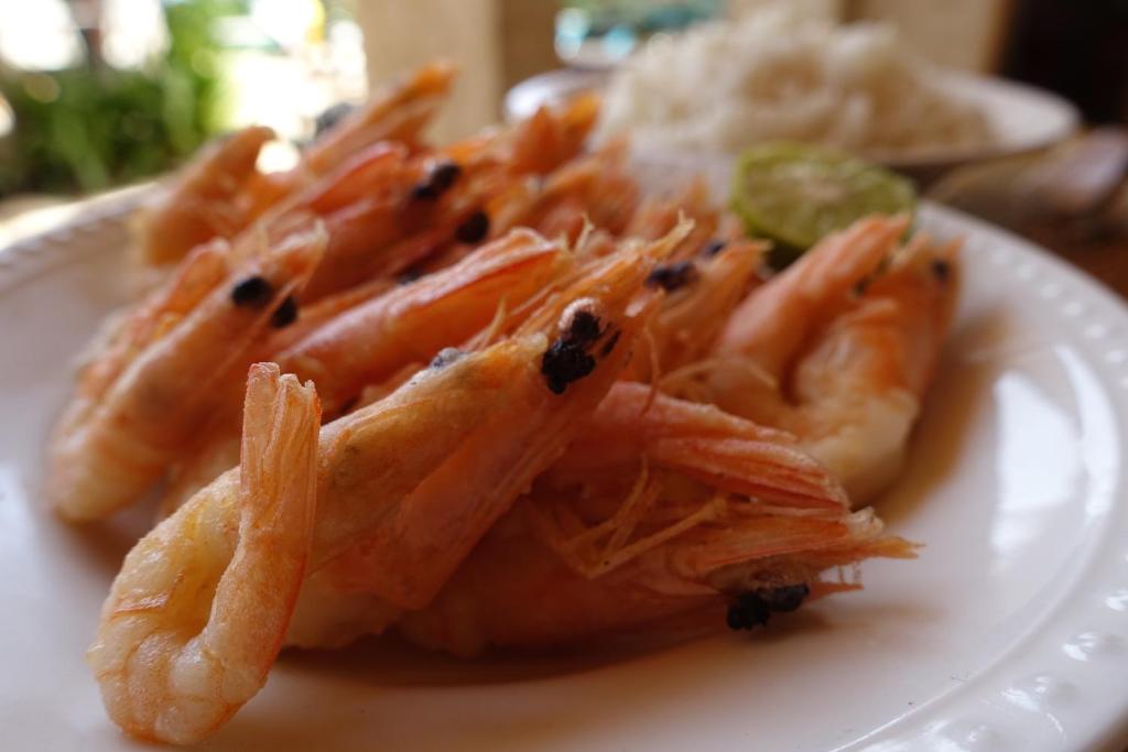 a white plate of food with shrimp on it at Keur Marrakis in Mbour