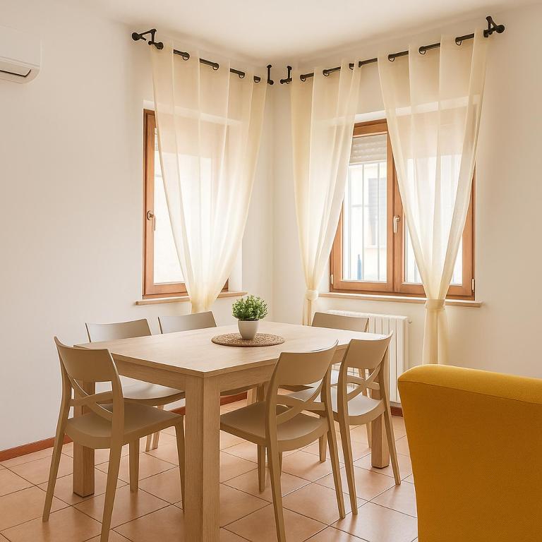 a dining room with a table and chairs at Via Milano 67 in Porto SantʼElpidio