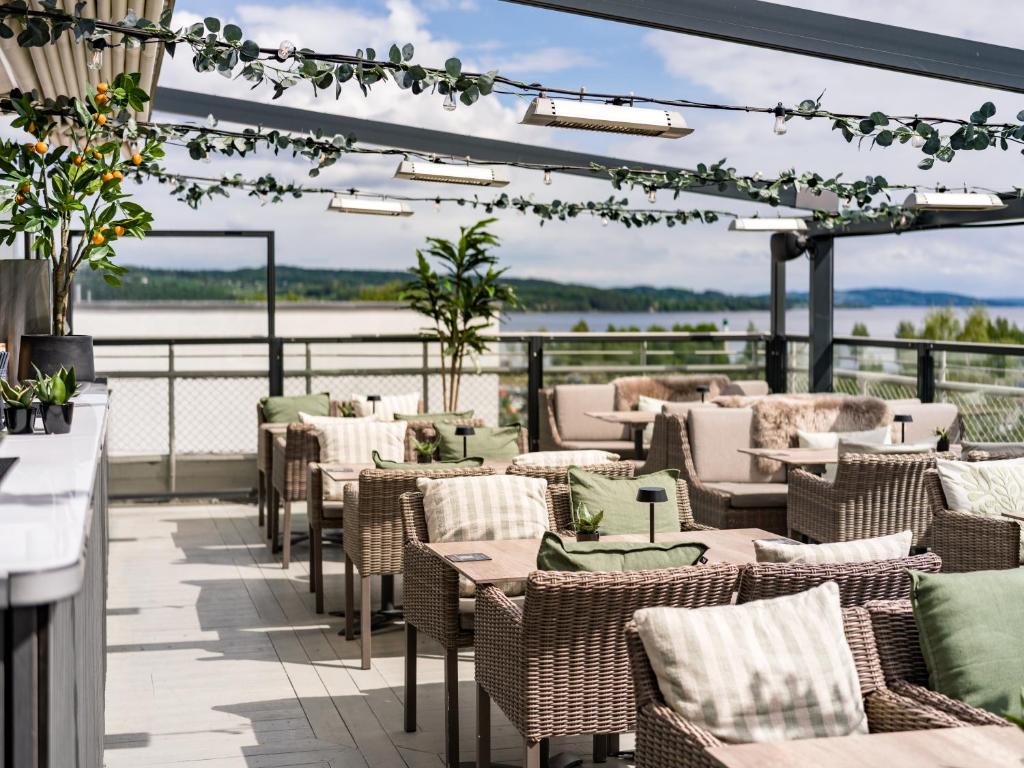 a restaurant with tables and chairs on a patio at Quality Hotel Strand Gjøvik in Gjøvik