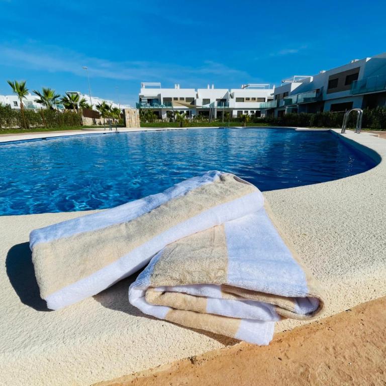 a towel sitting on the edge of a swimming pool at Casa Paloma Blanca in Orihuela
