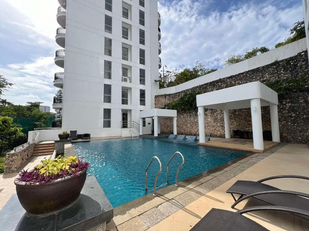 a swimming pool in front of a building at Oceanview Condo in Boracay in Boracay