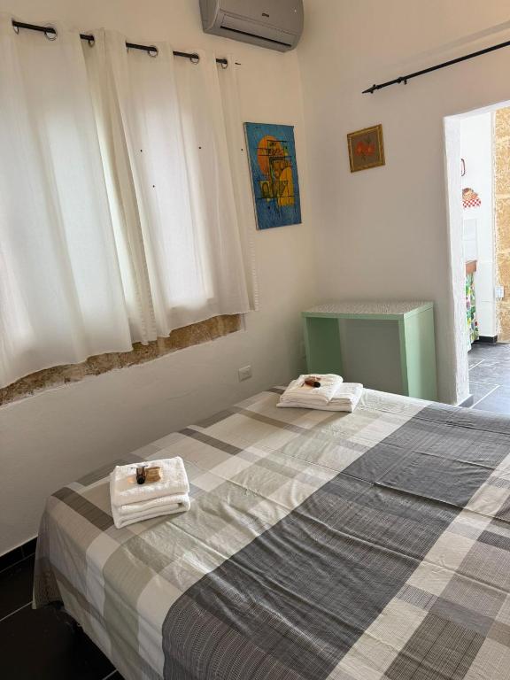 a bedroom with a bed with towels on it at Casavacanze Salento Stella in Veglie
