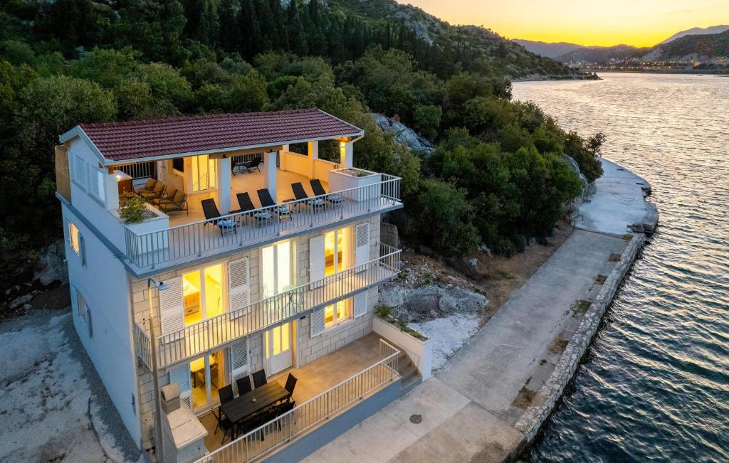 an aerial view of a house on the water at Nice Home In Rogotin With Harbor View in Rogotin
