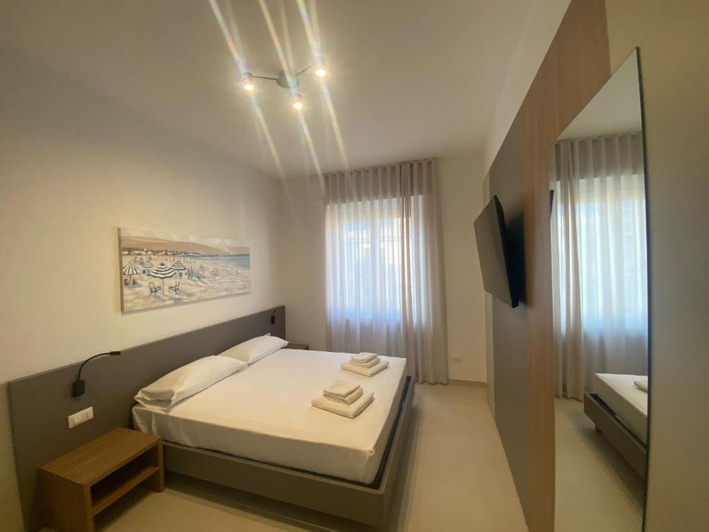 a small bedroom with a bed and a mirror at MONTELLA B&b in Gaeta