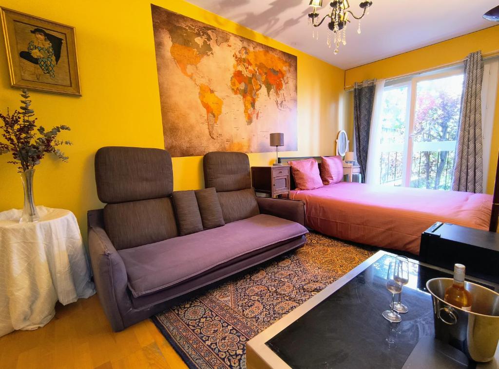 un salon avec un canapé et un lit dans l'établissement Charming Guesthouse 7min from Eiffel Tower, à Paris