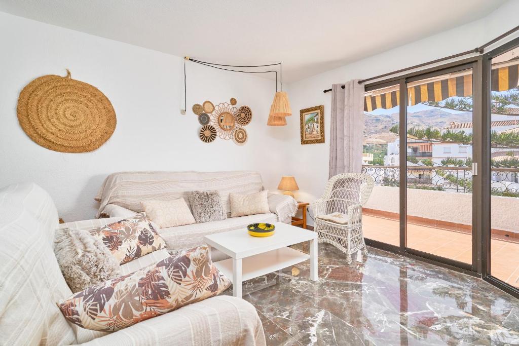a living room with a couch and a table at Lily in Almuñécar