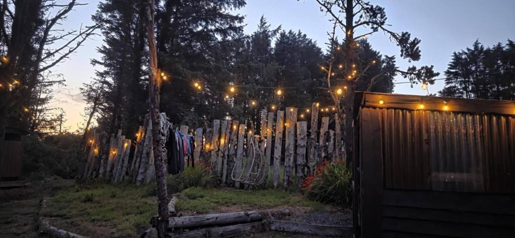 a fence with a string of lights on it at Yurt Pitch - TY GRUG RETREAT in Puncheston