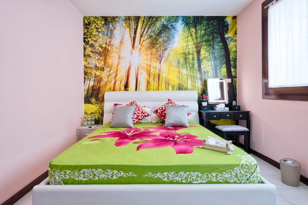 a bedroom with a bed with a painting on the wall at Villa jolly venezia in Venice