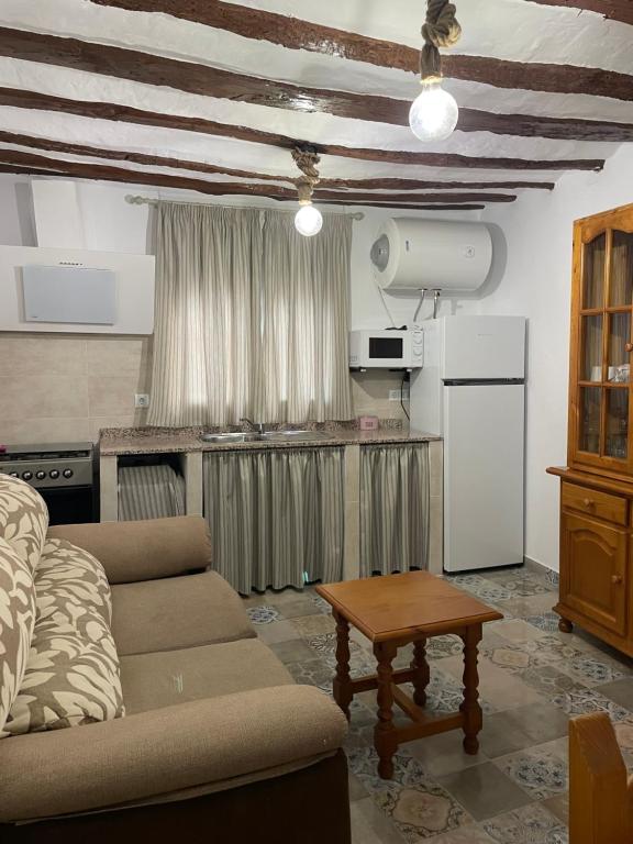 a living room with a couch and a table at Apartamento rural La Sabina in Zújar
