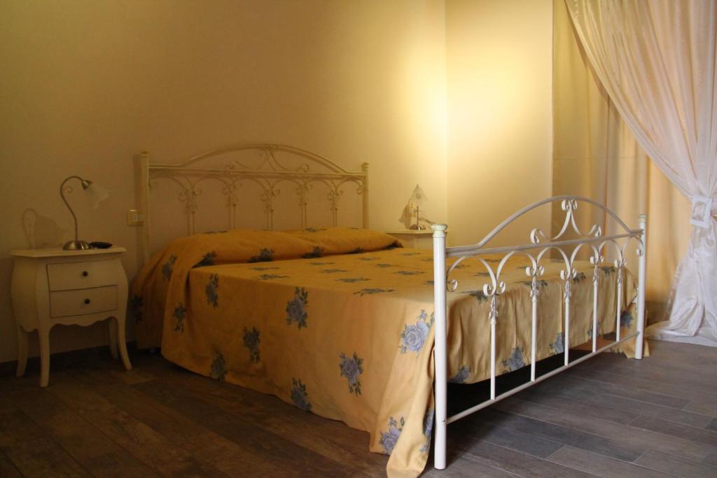 a bedroom with a bed and a dresser and a bed sidx sidx sidx sidx at B&B Maison La Coccola in Peschiera del Garda