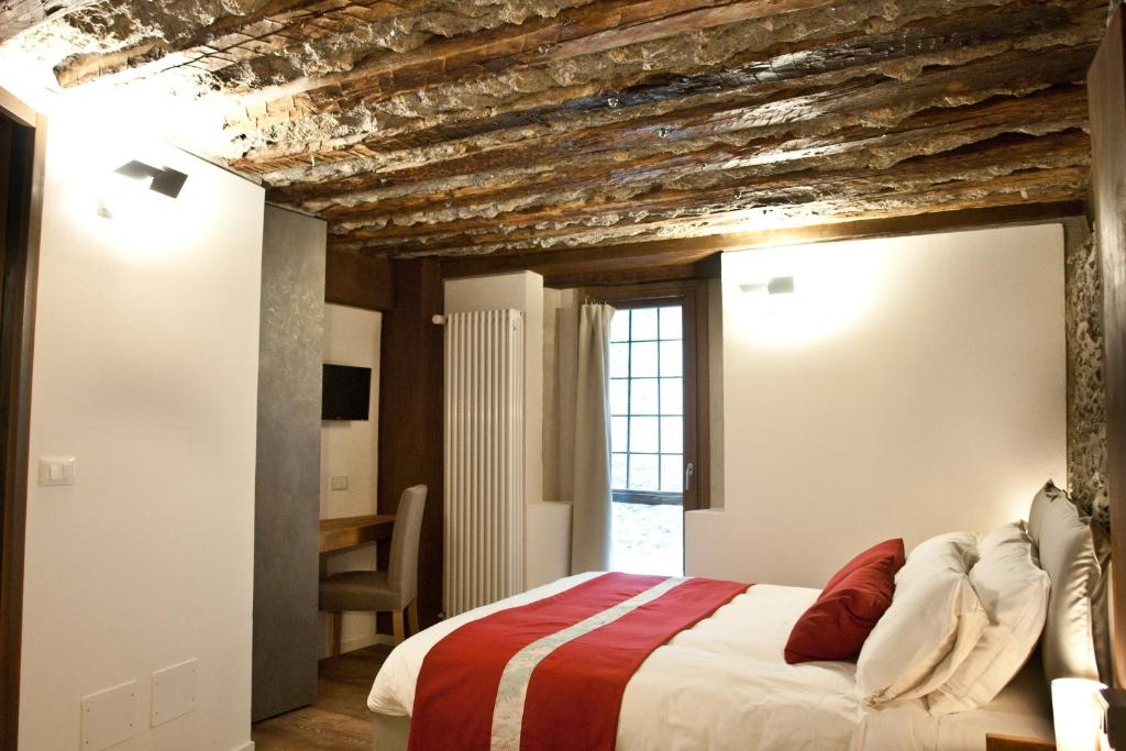 a bedroom with a bed with a brick ceiling at BnB 1504 in Oulx