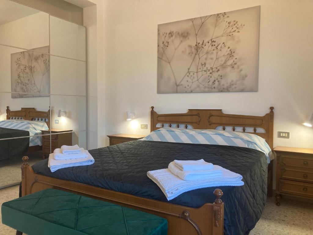 a bedroom with a bed with towels on it at Casa Nostra in Martinsicuro