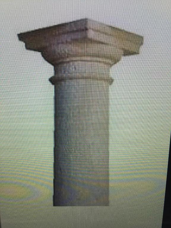 a stone pillar in the middle of a wall at casa el collado de sto tomas 