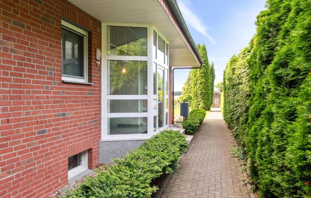 a brick building with a window and a brick sidewalk at 1 Bedroom Amazing Apartment In Dassow in Dassow