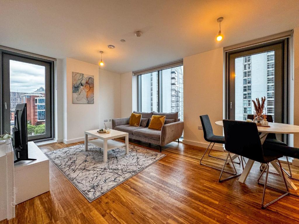 a living room with a couch and a table at Flat in Greater manchester in Manchester